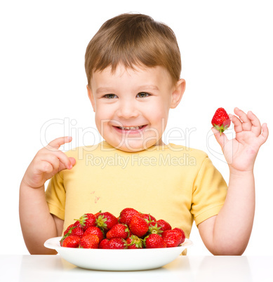 Happy little boy with strawberries