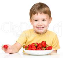 Little boy with strawberries