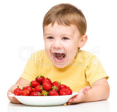 Happy little boy with strawberries