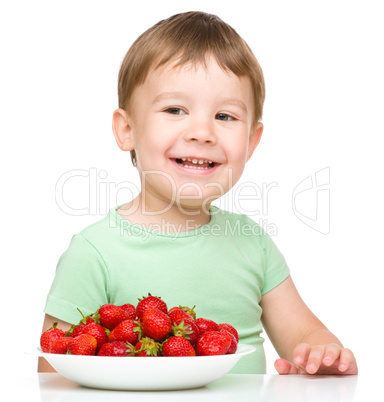 Happy little boy with strawberries