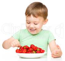 Happy little boy with strawberries