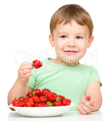 Happy little boy with strawberries