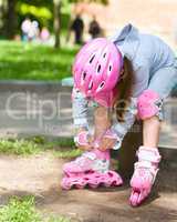 Little girl is wearing roller-blades