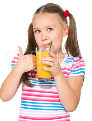 Little girl is drinking orange juice