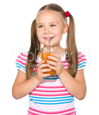 Little girl is drinking carrot juice