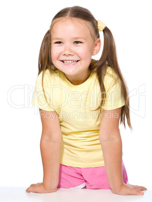 Portrait of happy little girl leaning on a table