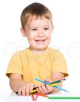 Little boy is holding color pencils