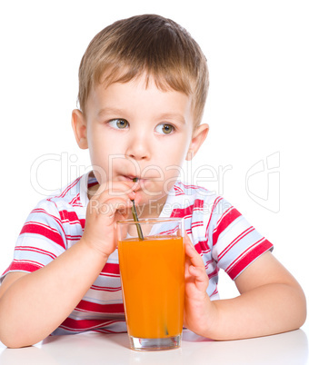 Little boy with glass of carrot juice