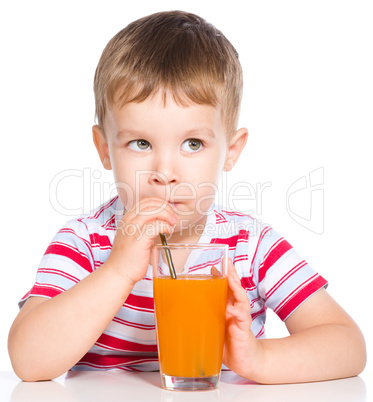 Little boy with glass of carrot juice