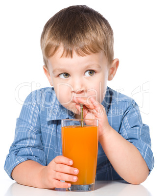 Little boy with glass of carrot juice