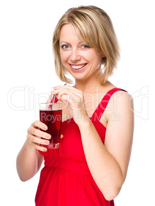 Young woman is drinking cherry juice