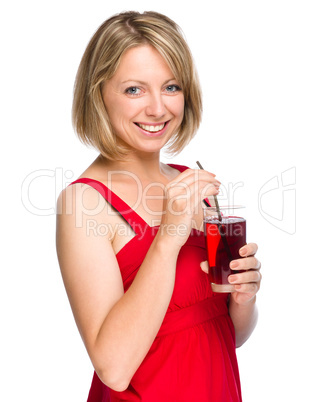 Young woman is drinking cherry juice