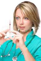 Young nurse is preparing syringe for injection
