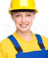 Young happy lady as a construction worker