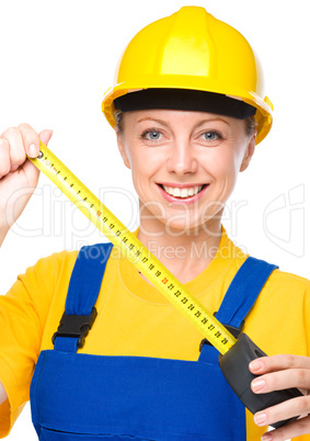 Young construction worker with tape measure