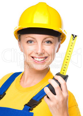Young construction worker with tape measure