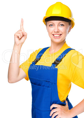 Young construction worker pointing up