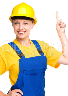 Young construction worker pointing up