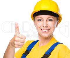Young construction worker is showing thumb up sign