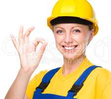 Young construction worker is showing OK sign