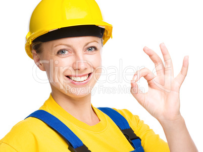 Young construction worker is showing OK sign
