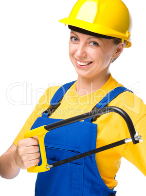 Young construction worker with hacksaw