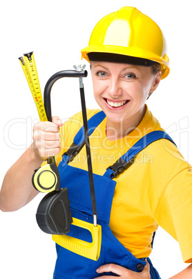 Young construction worker with hacksaw