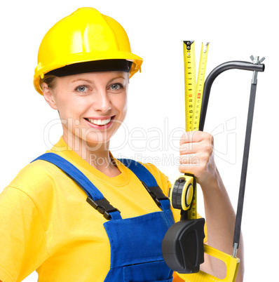 Young construction worker with hacksaw