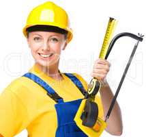 Young construction worker with hacksaw