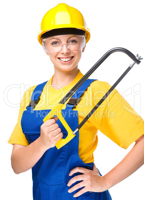 Young construction worker with hacksaw