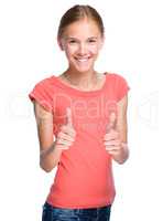 Young girl is showing thumb up gesture