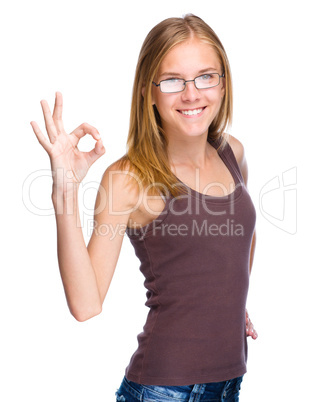 Young teen girl is showing OK sign