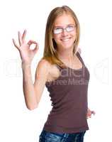 Young teen girl is showing OK sign