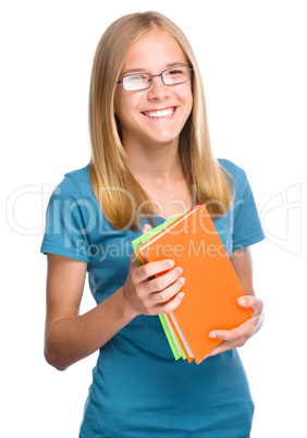 Young student girl is holding book