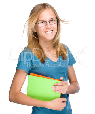 Young student girl is holding book