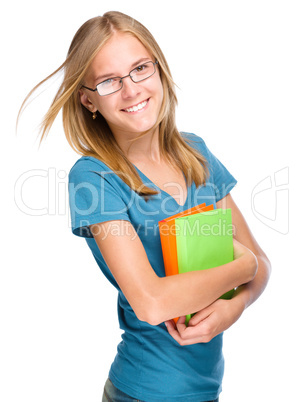 Young student girl is holding book