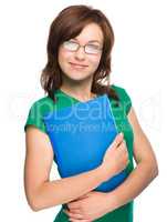 Young skinny student girl is holding exercise book