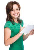 Young cheerful woman is using tablet