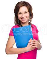 Young student girl is holding exercise book