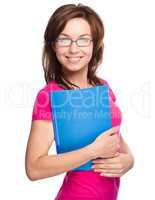 Young skinny student girl is holding exercise book