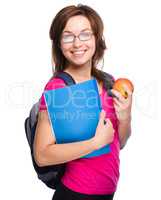 Young student girl is holding book and apple