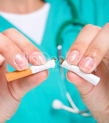 Doctor in uniform breaks cigarette