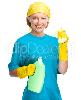 Young woman with cleaning liquid and sponge