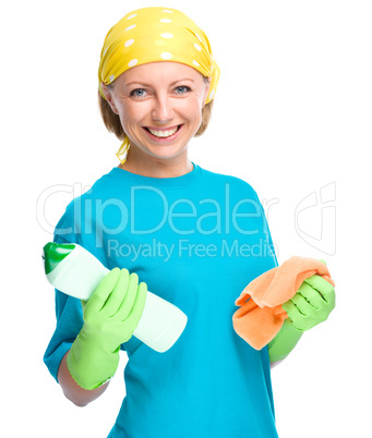 Young woman with cleaning liquid and rag