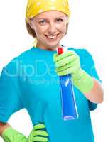 Young woman holding cleaning spray