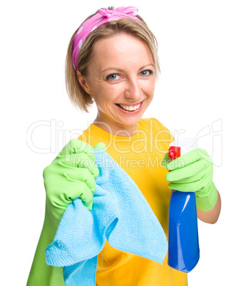 Young woman with cleaning liquid and rag