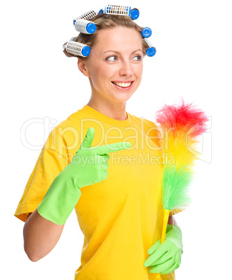 Young woman with curlers and static duster