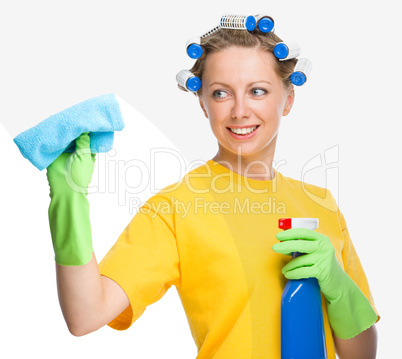Young woman is cleaning glass using rag