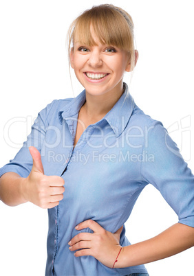 Woman is showing thumb up gesture