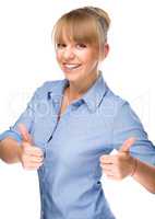 Woman is showing thumb up gesture